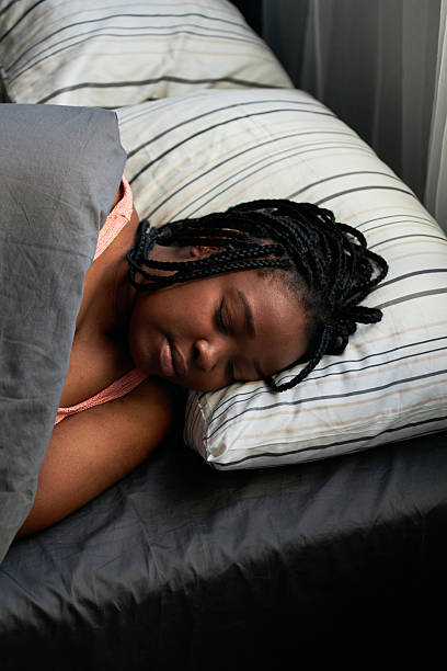 istock Young Black Woman Sleeping in Bed at Home 2231077470