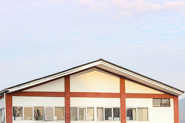 Detail of a contemporary, Gothic-style building against a blue sky at sunset.