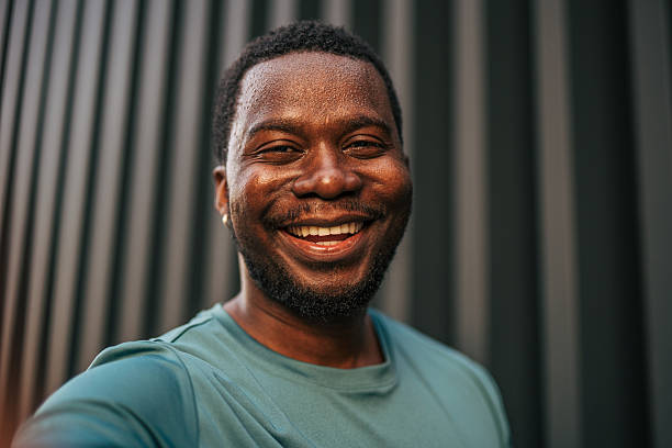 istock Young african american man smiling and taking a selfie 2231079580
