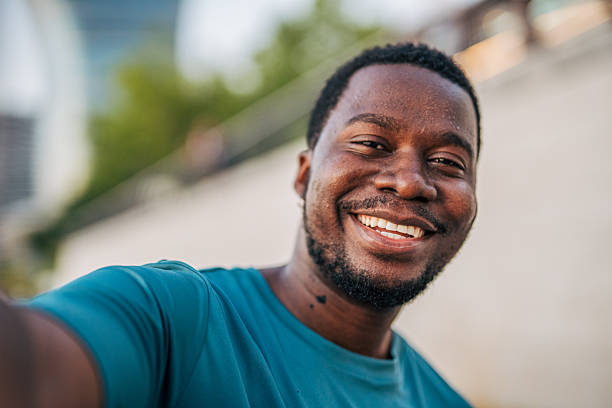 istock Young man taking a selfie and smiling at the camera 2231080600