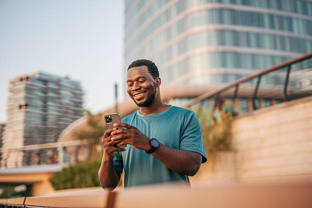 istock Smiling young man using smartphone after workout in city 2231080664