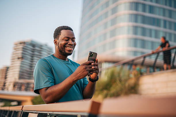 istock Young sportsman using phone app after training 2231080666