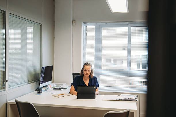 istock Businesswoman working on a tablet in the office 2231081008
