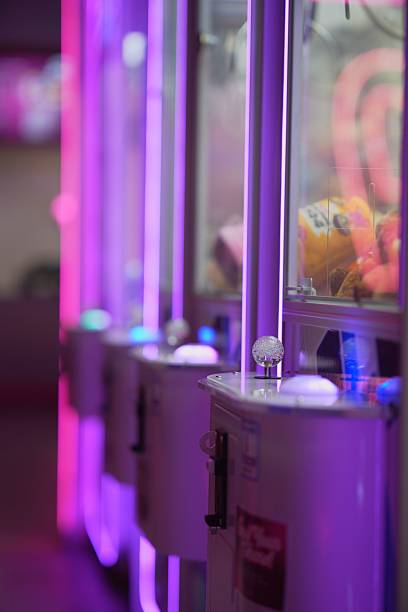 istock Vibrant claw machines in arcade lighting. 2231082493