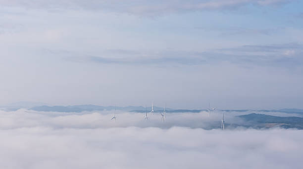 istock Wind turbines poking through the clouds 2231085038