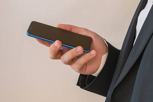 istock Hand holding phone with black inactive screen close-up, no signal, no mobile internet, discharged non-working phone, data retention issues 2231085199