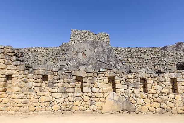 Archaeological site of Machu Picchu in Peru at daylight.\nMachu Picchu is a 15th-century Inca citadel located in the Eastern Cordillera of southern Peru on a mountain ridge at 2,430 meters. It is situated in the Machupicchu District of Urubamba Province about 80 km northwest of Cusco, above the Sacred Valley and along the Urubamba River, which forms a deep canyon with a subtropical mountain climate.
