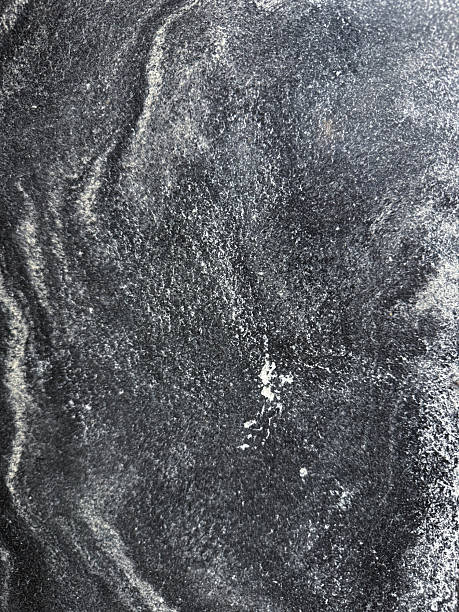 istock Close-up texture of dark stone or marble surface with natural white veining and patterns. Abstract mineral background, perfect for use in design, interiors, architecture, and as a high-resolution 2231086239