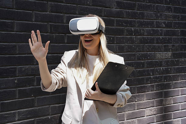 istock Businesswoman using virtual reality headset in a modern city setting 2231087715