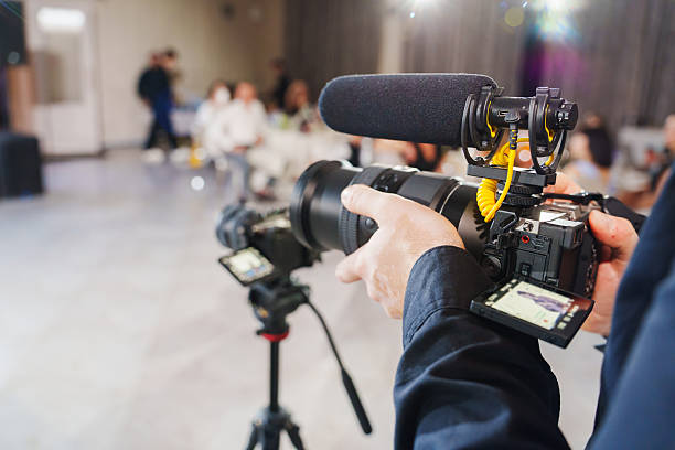 istock Professional photographer capturing a lively event with video equipment 2231088967