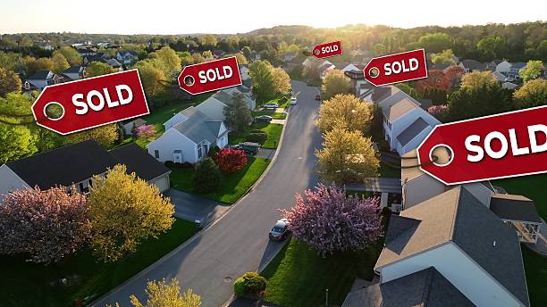istock Modern American neighborhood with animated sold tags over rooftops 2231090478