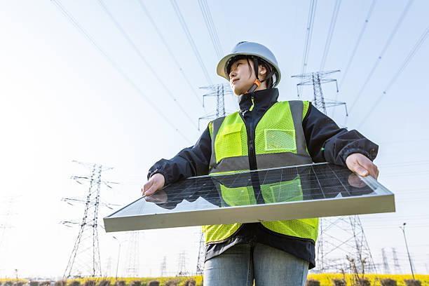 istock Female engineer holding solar panels working in the field 2231090673