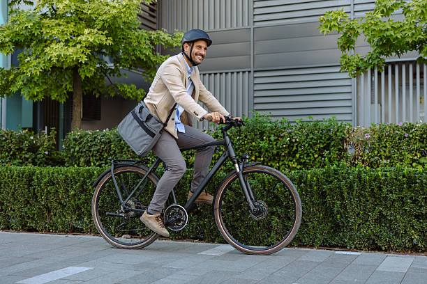 istock Businessman commuting on a bicycle through a modern urban environment 2231092620