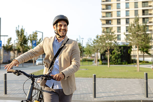 istock Smiling man commuting on a bicycle in an urban environment 2231092681