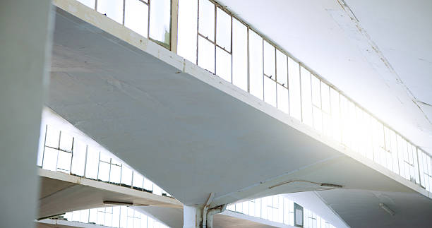 istock Warehouse, industrial architecture and empty building with interior design for shelter or structure. Workshop, walls and pilars of concrete construction with solid infrastructure or development 2231092796