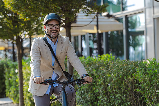 istock Smiling professional cycling to work in an urban environment 2231092847