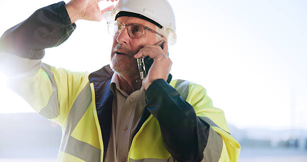 istock Contractor, man or stress with phone call on site for building inspection fail, problem or feedback. Construction, mature person and talking to contact for project management, safety risk and mistake 2231092939