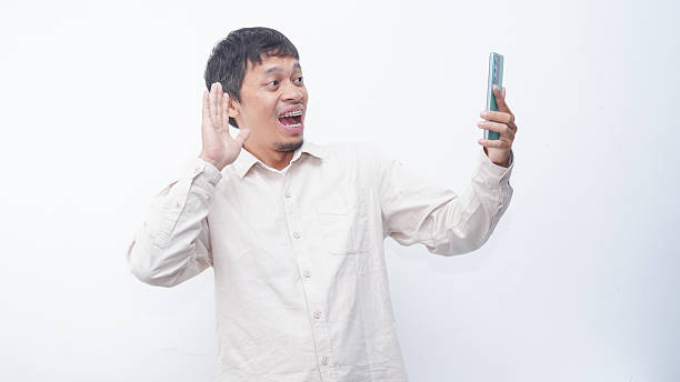 istock Asian man make a video call and make a waving hand gesture 2231093028