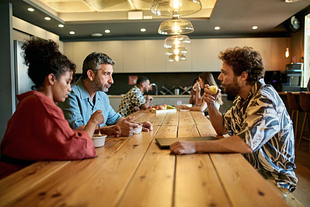 istock Project team eating salads and discussing ideas 2231093546