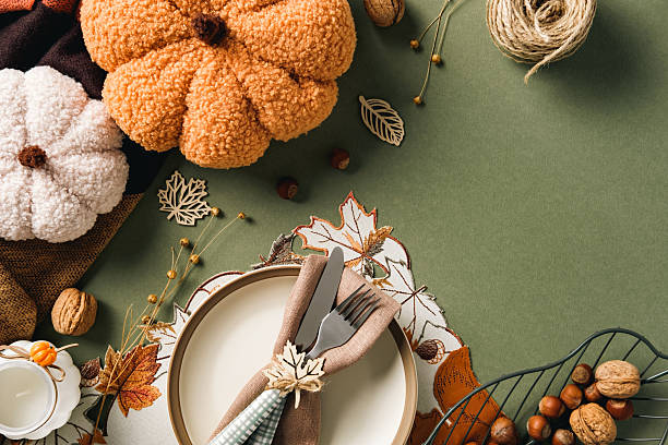 istock Autumn table decor with plush pumpkins, rustic cutlery, and warm seasonal elements. Perfect for fall, Thanksgiving, and cozy lifestyle themes. 2231093747