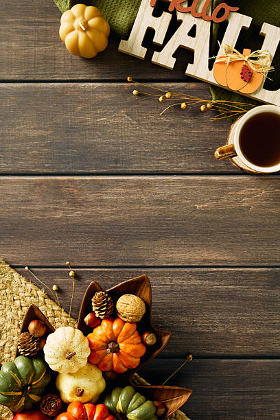 istock Vintage autumn flat lay composition. Vertical wooden background with sign Hello Fall, pumpkins, dry flowers, pine cones, candles. Top view. 2231097197