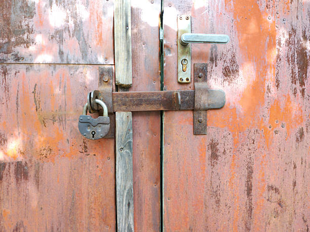 iron bolt and padlock on a closed door. protection of home and property from theft and unauthorized access