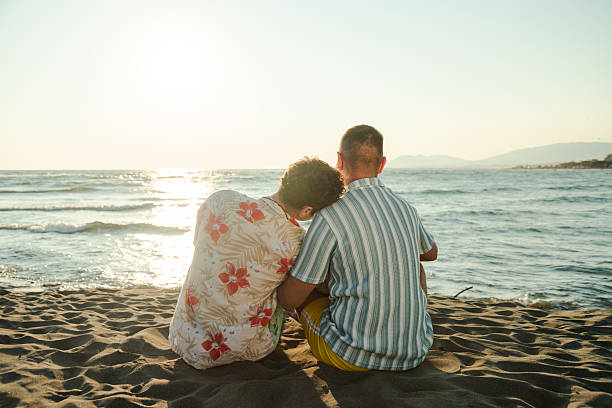 istock Couple enjoying a peaceful moment at the beach during sunset 2231099619