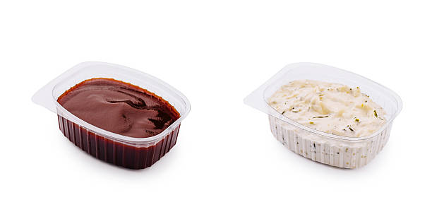 istock Savory barbecue sauce in clear plastic container on a white background 2231099756