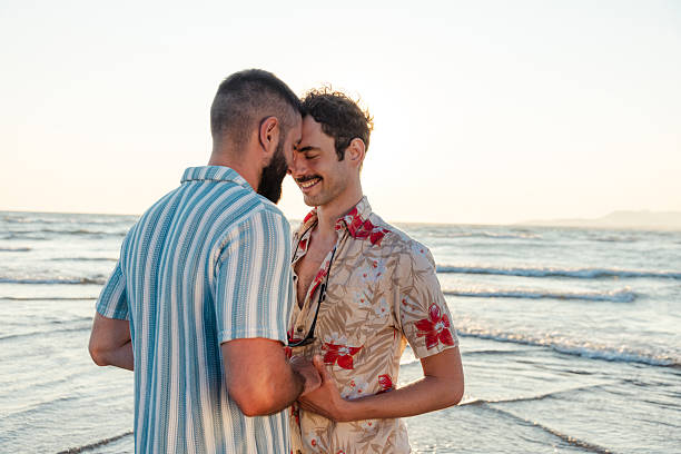 istock Loving couple embracing on a beach at sunset 2231099803