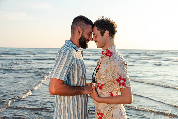 istock Two men share an intimate moment at the beach during sunset 2231099812