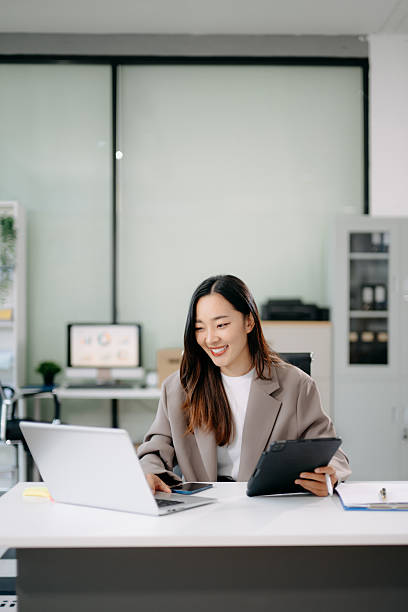 istock sian businesswoman working with working notepad, tablet and laptop documents in the office 2231100229
