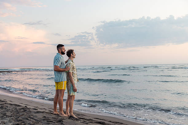 istock Two men enjoying a romantic moment together at the seaside 2231100233