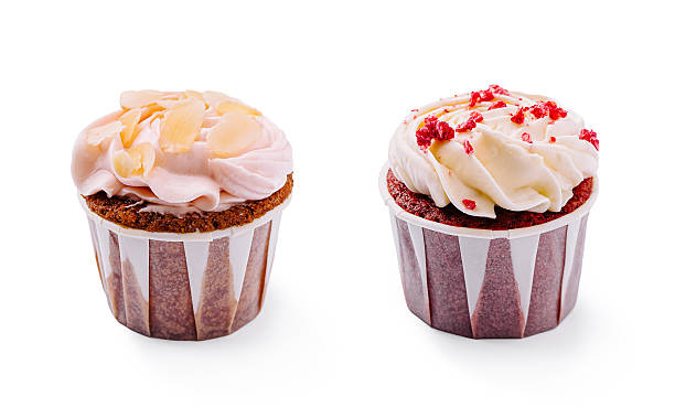 Delightful cupcake topped with frosting and almond slices on a white background