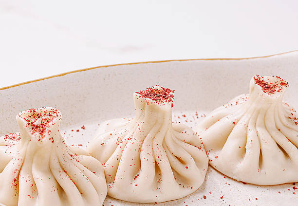 Delightful dumplings served with a sprinkle of seasoning on a white plate