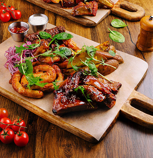 istock Savoring barbecue platter with assorted meats and vegetables at a rustic setting 2231101305