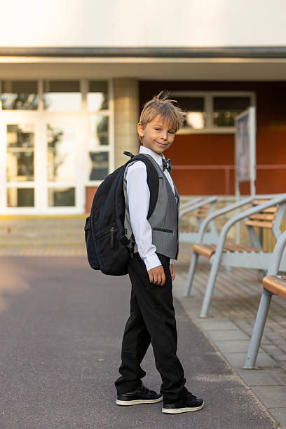 istock Cute first grade school child,  going to school. First day at school for a firstgrader, child starting school, caring backpack 2231102845