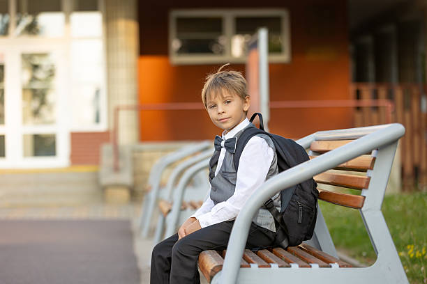 istock Cute first grade school child,  going to school. First day at school for a firstgrader, child starting school, caring backpack 2231102925