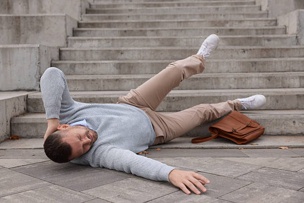 istock Injured man on stairs outdoors after fall. Dangerous accident 2231103481