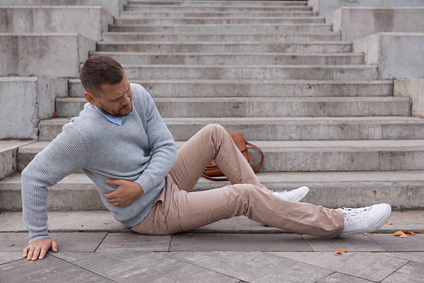 istock Injured man on stairs outdoors after fall. Dangerous accident 2231103522