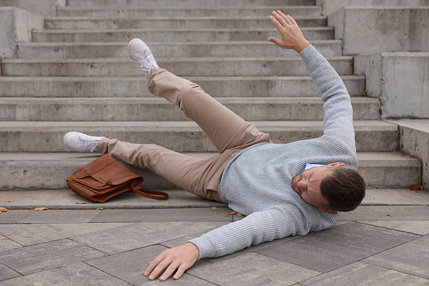 istock Injured man on stairs outdoors after fall. Dangerous accident 2231103532