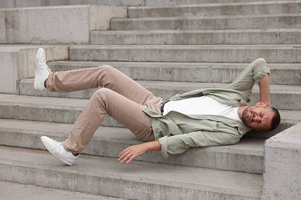 istock Man with injured head on stairs outdoors after fall. Dangerous accident 2231103645