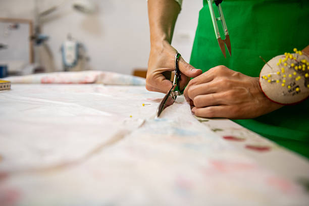 istock Seamstress in a sewing workshop Hands Close Up 2231103705