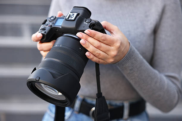 istock Professional photographer with digital camera outdoors, closeup 2231104213
