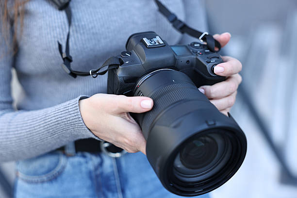 istock Professional photographer with digital camera outdoors, closeup 2231104239