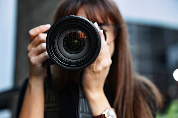 istock Professional photographer taking picture with camera outdoors, selective focus 2231104339