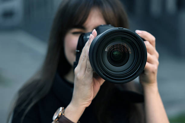 istock Professional photographer taking picture with camera outdoors, selective focus 2231104359