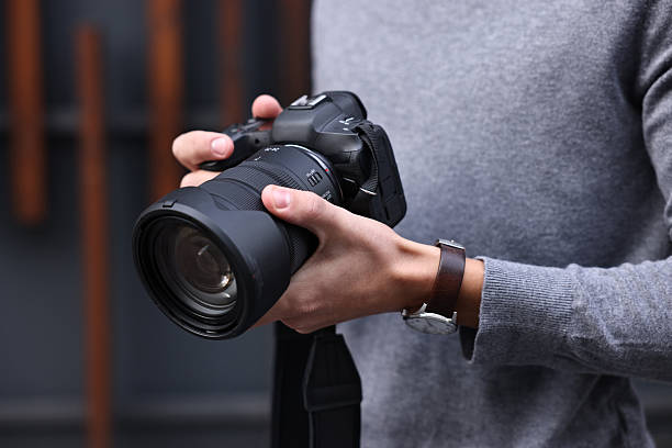 istock Professional photographer with modern camera outdoors, closeup 2231106552