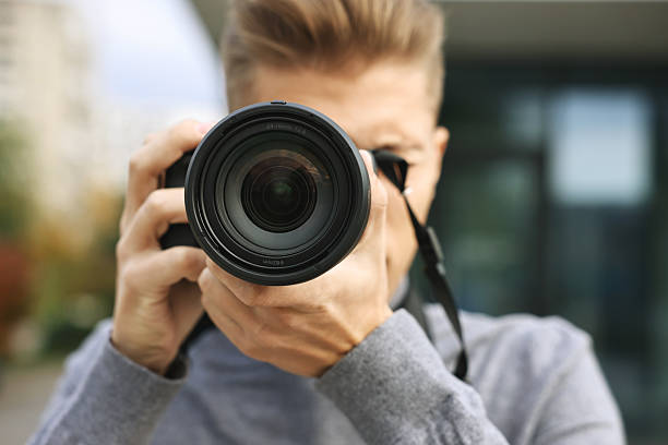 istock Professional photographer taking picture with camera outdoors, selective focus 2231106554