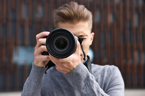 istock Professional photographer taking picture with camera outdoors, selective focus 2231106581