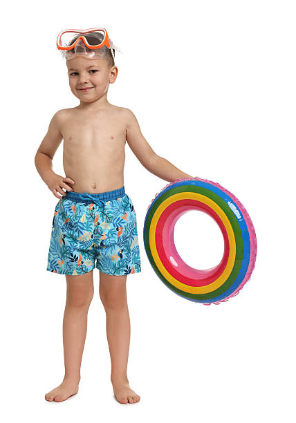 istock Cute little boy in beachwear with inflatable ring on white background 2231109379